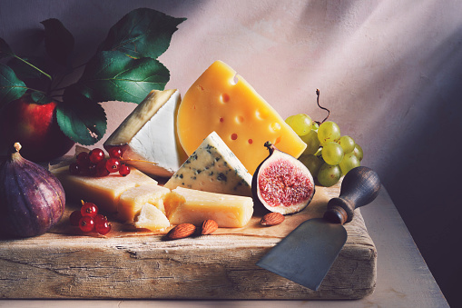 Different types of cheeses with fig, currant and grape