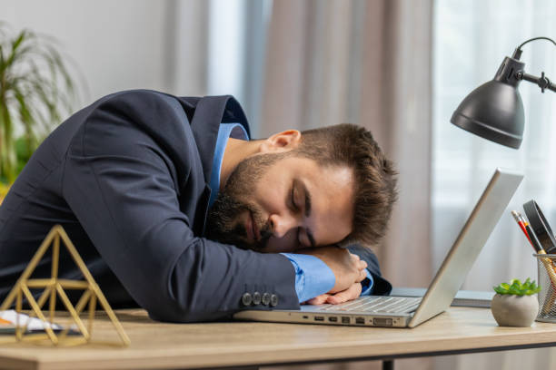 istock Bored sleepy Caucasian business man worker working on laptop computer, falling asleep at home office 1677021822
