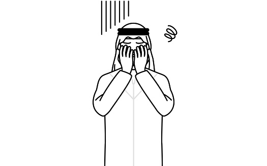 Muslim Man covering his face in depression.
