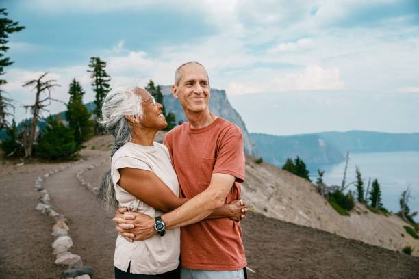 istock Active senior couple enjoying scenic view while on a hike 1677022592
