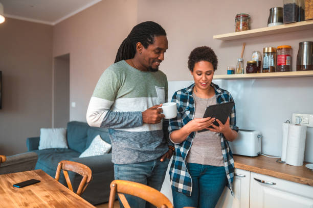 istock Lovely Couple In A Domestic Kitchen Using Digital Tablet 1677063999