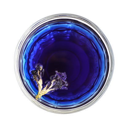 Organic blue tea Anchan, Clitoria, Butterfly Pea in glass isolated on white background, top view
