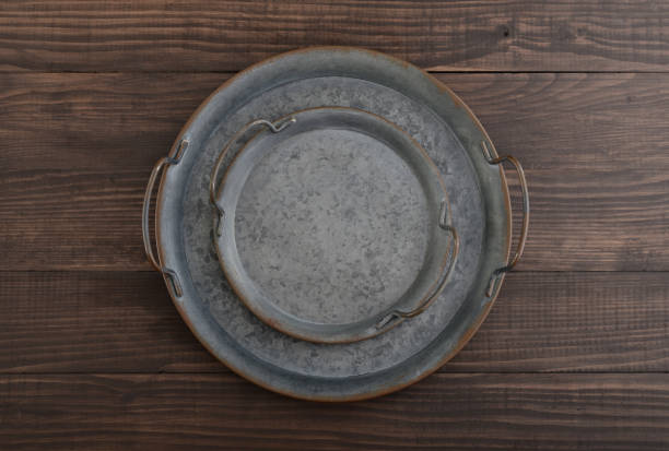 Vintage metal round tray on wooden background, top view