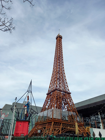 Ituzaingo, Argentina - Jul 29, 2023: Replica of the Eiffel tower, artwork by Ruben Diaz, at the entrance of a beer house in Ituzaingo, Buenos Aires Province, Argentina.