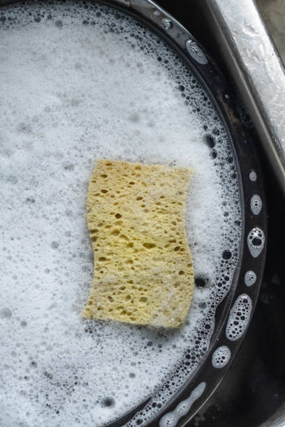 washing dirty dishes sponge and dish sope stock photo