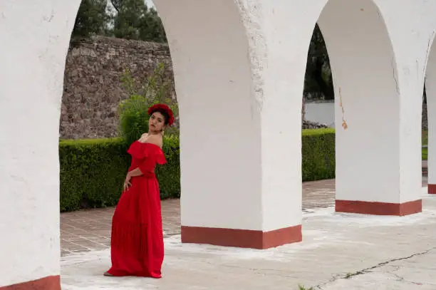 Pretty Young girl wearing classical mexican dress red, like flamingo