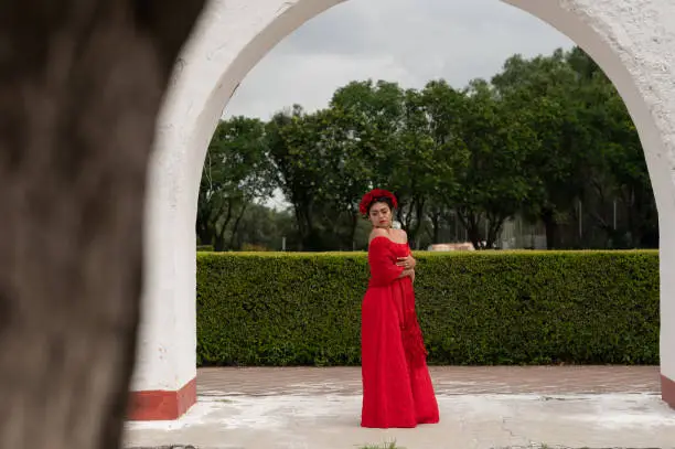 Pretty Young girl wearing classical mexican dress red, like flamingo