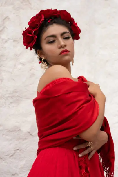 Pretty Young girl wearing classical mexican dress red, like flamingo