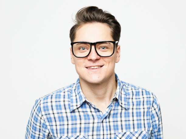 Portrait of a young man wearing casual standing against white background stock photo