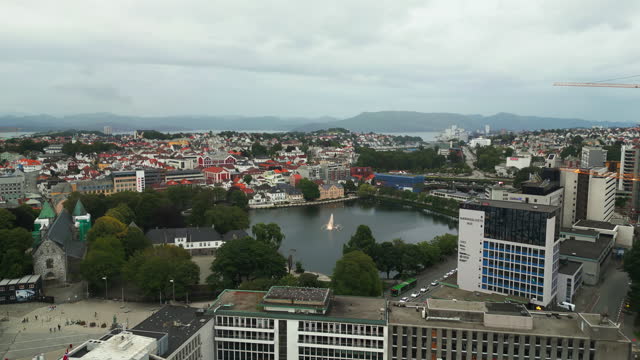 Aerial dolly toward Breiavatnet lake with fountain in Stavanger city, Norway