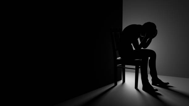 istock 3D Man Sitting on Chair in a Dark Room 1677199173