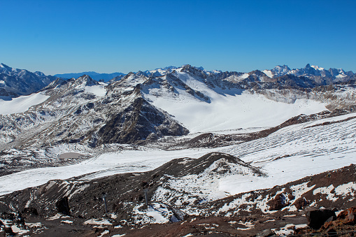 Mountains in Mount Elbrus region, the highest mountain peak in Russia and Europe, view from Mount Elbrus base camp. Blue sky with copy space for text