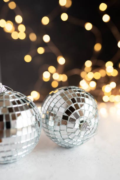 istock Two silver disco balls and gold party lights 1677230026