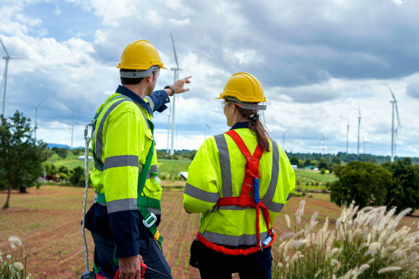 istock Two engineers plan on-site inspection and maintenance of wind turbines 1677252345
