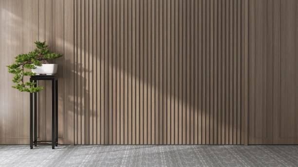 istock Japanese large bonsai tree in white pot in sunlight from window, shadow on blank wood panelling wall, gray carpet floor 1677263545
