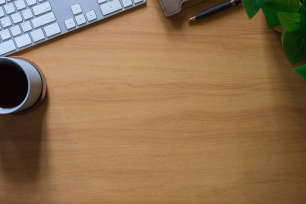 istock Simple workspace with keyboard, coffee cup and book on wooden table. Top view with copy space for text. 1677265750
