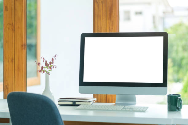 istock Contemporary workplace with blank screen computer monitor, coffee cup and books. 1677268242