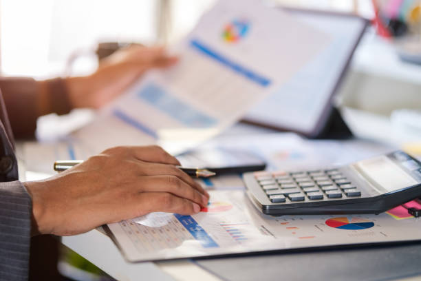 istock Financier accountant using calculator for calculating reports and summarizing accounts. 1677268654