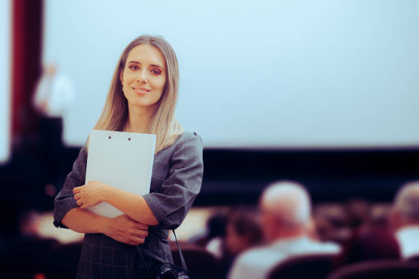 istock Happy Woman Holding a Clipboard Attending a Conference 1677268664