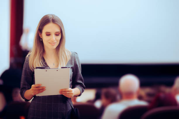 istock Happy Woman Holding a Clipboard Attending a Conference 1677268682