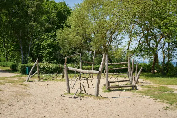 public playground with wooden playground equipment for children near the beach in German Baltic resort Kühlungsborn Ost