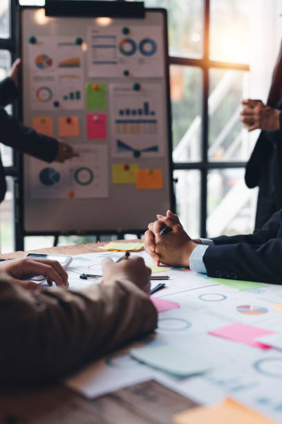 Group of Business people meeting creative planning and development strategy using graphs, charts, presented at company sales strategy marketing meeting.