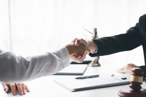istock Client shaking hands with a lawyer or discusses a successful contract agreement. Shake hands to congratulate on the success of winning the case. 1677301263