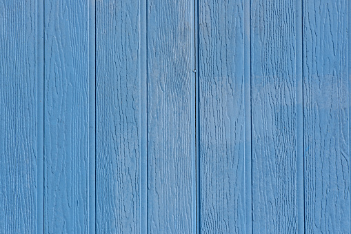 Close-up on a light blue wooden fence