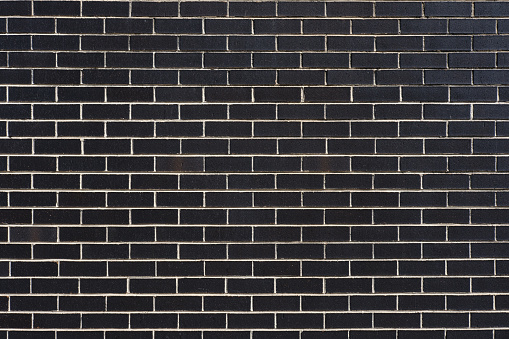 Section of a black brick wall.