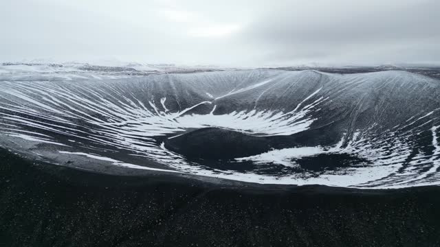Drone shot revealing landscape of Hverfjall Volcano Crater in winter, Iceland