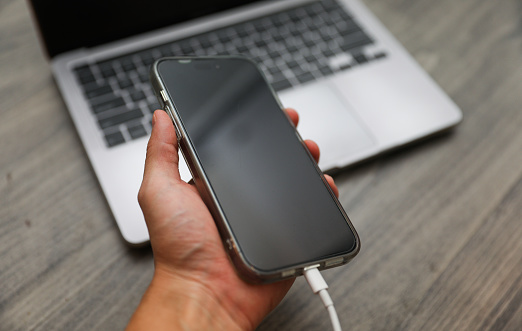 chicago, IL, USA, Sept, 13, 2023, Futuristic USB-C iPhone charging: A sleek device connected via USB-C cable, symbolizing cutting-edge technology and efficient power delivery
