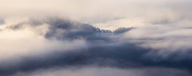 istock A thick fog covered the mountains, a top view, banner 1677394581
