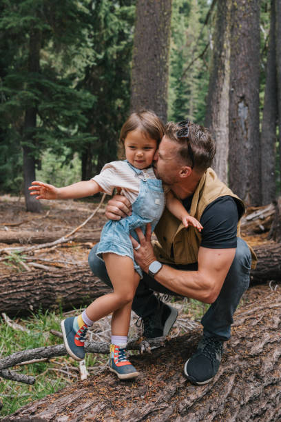 istock Loving father kisses daughter's cheek while hiking 1677397544