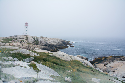 Peggy's Cove, Canada - August 13, 2015:people near the Peggy's Cove lighthouse in Nova Scotia-Canada during a foggy day