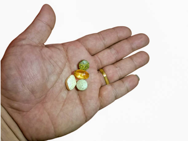 istock Various kinds of pills on hand. Isolated on white background. 1677427381