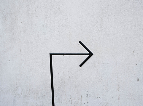 arrow black line on cement wall.