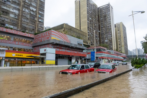 2023 Sept 8,Hong Kong.After heavy rain in Hong Kong, flooding occurred on Lung Cheung Road in Wong Tai Sin. There are vehicles stop in the muddy water.