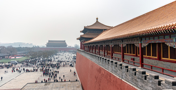Beijing, China, people at the gates of the ancient Forbidden City palace complex during summer.