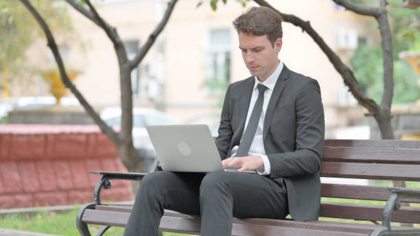 istock Businessman Working on Laptop Outdoor 1677461365