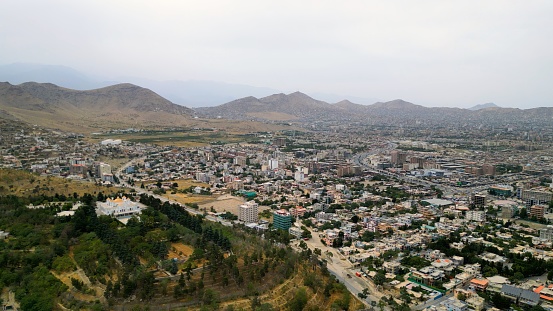 Aerial view of Kabul city Afghanistan. City road with cars and houses on the hills