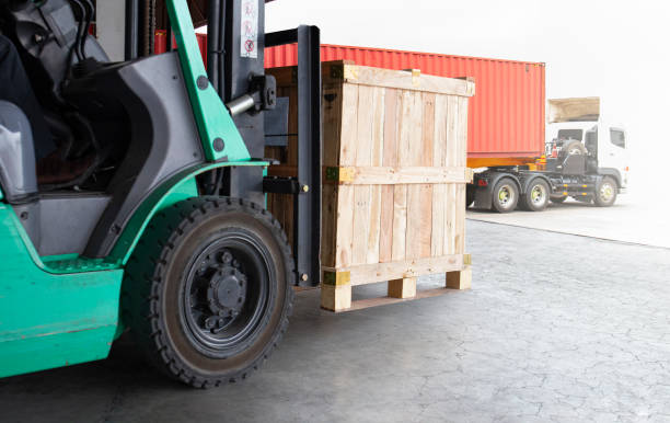 istock Forklift Tractor Unloading Wooden Crates at Warehouse. Container Truck Loading Dock Warehouse. Cargo Sending to Customers. Shipment Supplies Warehouse Shipping. Freight Truck Logistic Transport. 1677518177