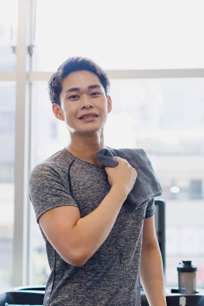istock Young Asian man with towel at gym 1677531096