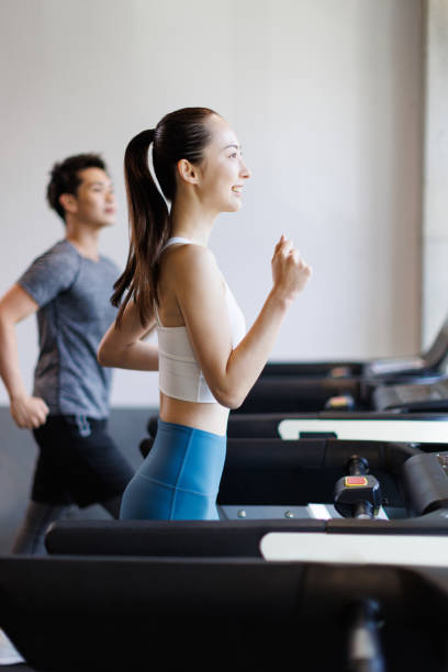 istock Young Asian adults running on treadmills 1677532788