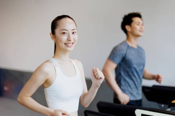 istock Young Asian adults running on treadmills 1677532789