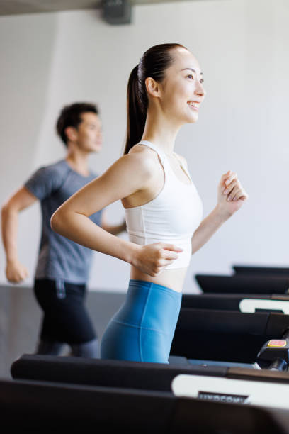 istock Young Asian adults running on treadmills 1677533309