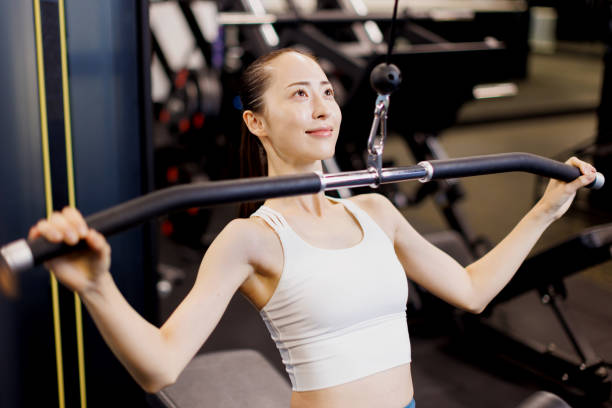 istock Young Asian woman exercising on lat pulley 1677533856