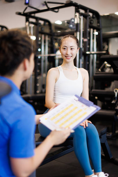 istock Personal trainer discussing with client at gym 1677534939