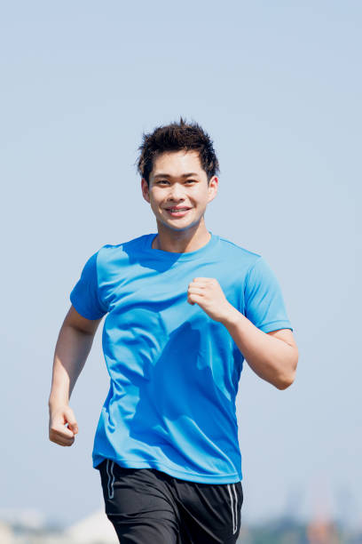 istock Young Asian man jogging outdoors 1677539926