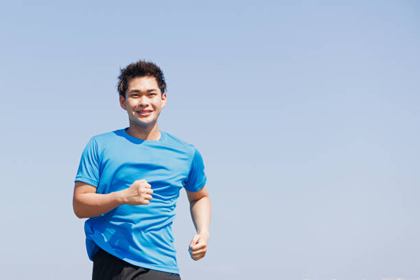 istock Young Asian man jogging outdoors 1677540443