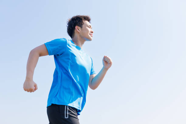 istock Young Asian man jogging outdoors 1677540459